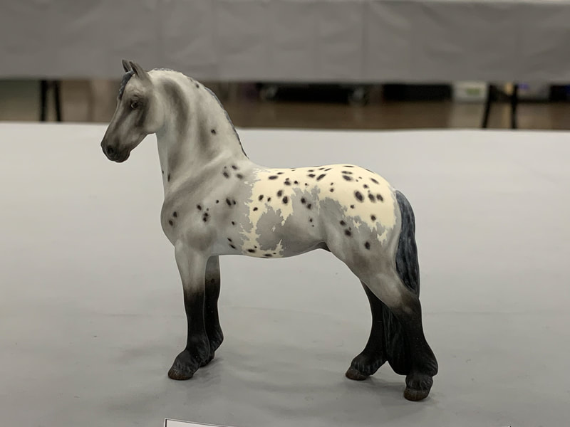 A customized Breyer Stablemate Friesian at The Jennifer Show 2019.