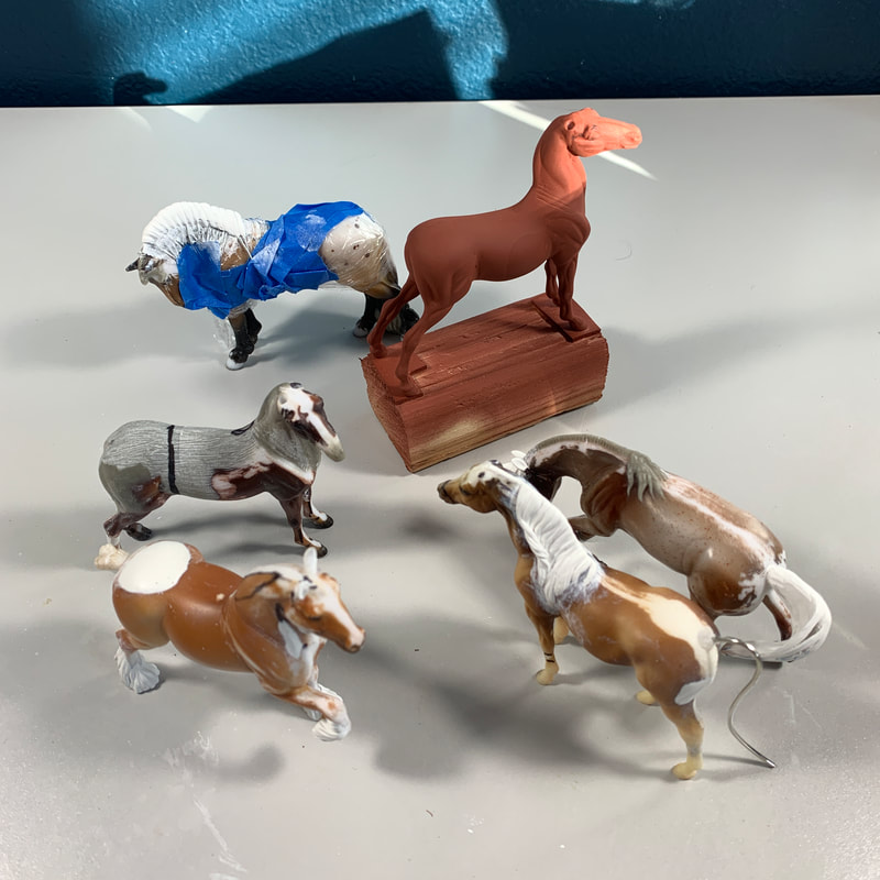 An assortment of Breyer Stablemates customs in various stages of remaking, to include an American Saddlebred, Mangalarga Marchador, Shire, Aarbian horse, and Criollo.