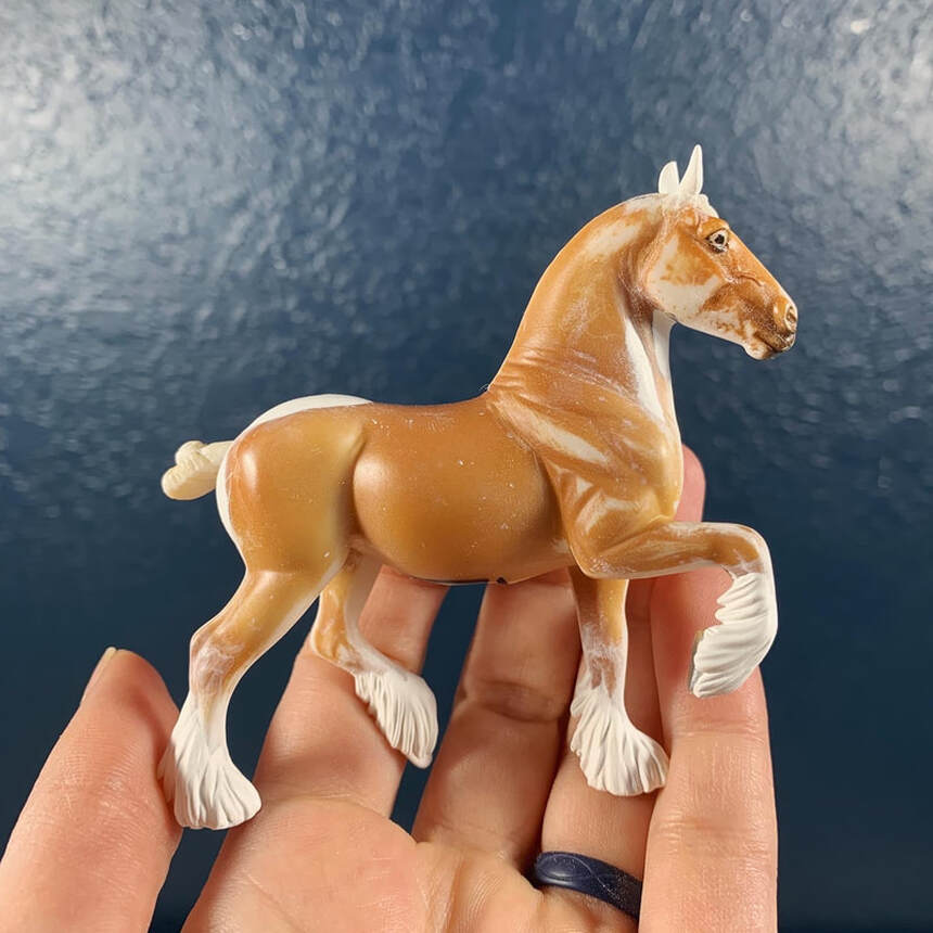 A Breyer stablemate Belgian horse that I am resculpting into a show Shire with drastic customizing.