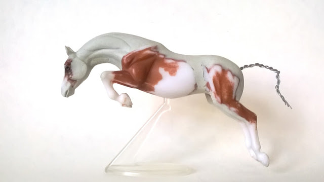 A Breyer Stablemate G3 jumping horse with a new head, neck, lengthened back and reworked hindquarters.